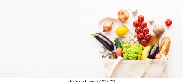 Cotton Grocery Tote Bag With Fresh Vegetables, Fruits, Baguette And Canned Good On Wooden Background. Healthy Food Shopping, Eco-friendly Concept. Flat Lay, Copy Space.