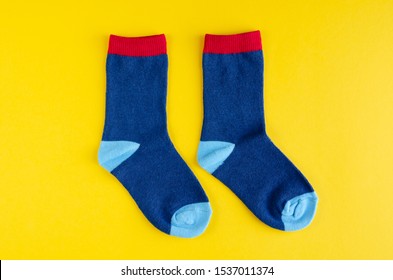 Cotton Kids Socks Composition On Yellow Background. Flat Lay, Layout And Tabletop Mockup With Copy Space.