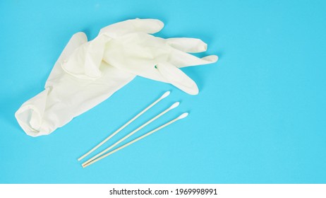 Cotton Sticks For Swab Test With White Medical Gloves Or Latex Glove On Blue Background.covid-19 Concept,no People