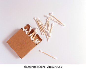 Cotton swabs made of bamboo in a cardboard box. Top view, white background - Shutterstock ID 2185371055