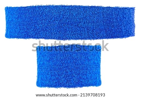 Cotton training headband and wristband isolated on a white background, blue color. Sport equipment.