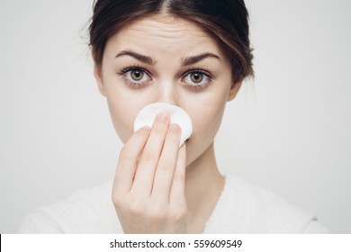 Cotton White Disc. Facial Cleansing. A Woman Cleans The Face With A Cotton Pad