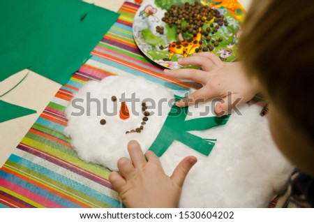 Cotton-wool body and black pepper eye snowman. DIY 3D Paper and Wadding Game for Children.
