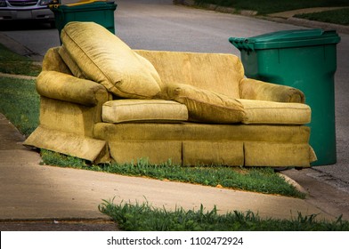 Couch Placed By Curbside Next To Garbage Can On Bulk Trash Pickup Day.