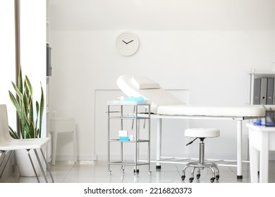 Couch and table with doctor's supplies in modern medical office - Powered by Shutterstock