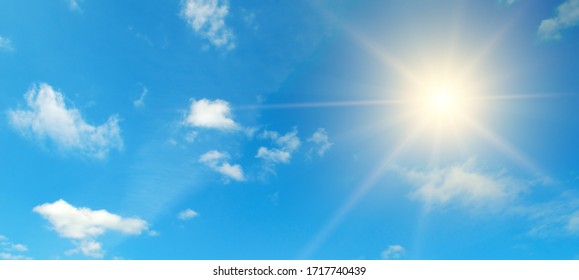 Couds in the blue sky. Bright midday sun illuminates the space.Wide photo . - Shutterstock ID 1717740439