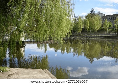 couds reflected in the calm river