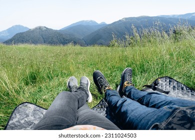 Coue resting on blanket by the mountains - Shutterstock ID 2311024503