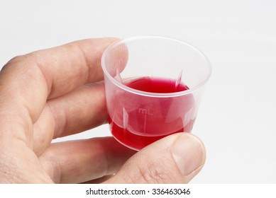 Cough Medicine In Measuring Cup