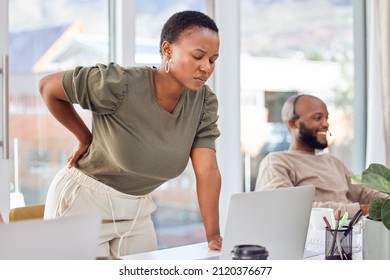 Could It Be My Chair Or Something Else.... Shot Of A Businesswoman Experiencing Back Pain While Getting Up From Her Desk.