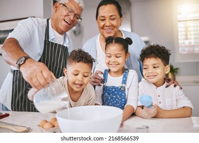 Could I Have A Glass When Youre Done. Shot Of A Mature Couple Baking With Their Grandkids At Home.