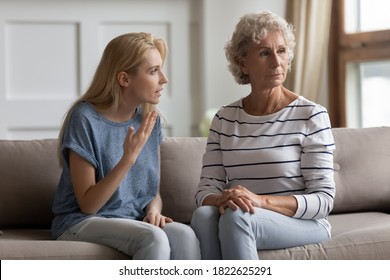 Could you just hear me? Two generations family elderly mother and young daughter quarrelling, having conflict, stressed nervous grown kid trying to explain prove something to mom unwilling to listen