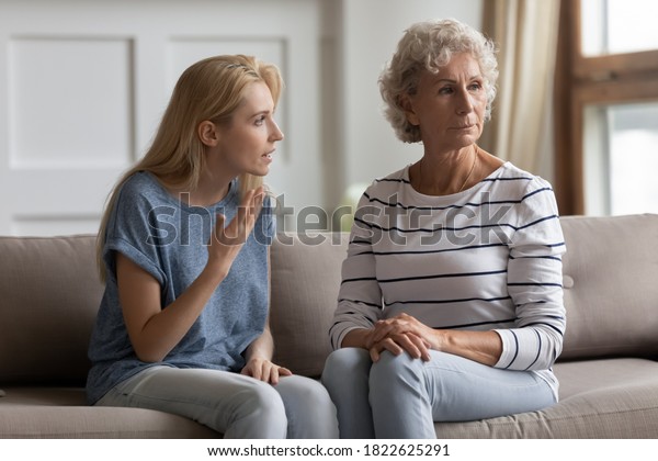 Could you just hear me? Two generations family
elderly mother and young daughter quarrelling, having conflict,
stressed nervous grown kid trying to explain prove something to mom
unwilling to listen