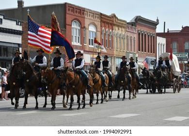 Council Grove, Kansas, USA, June 19, 2021 
Members of the Fort Riley Commanding General's Mounted Color Guard outfitted in the uniforms and equipment of the Civil War ride in the Washunga Days Parade 