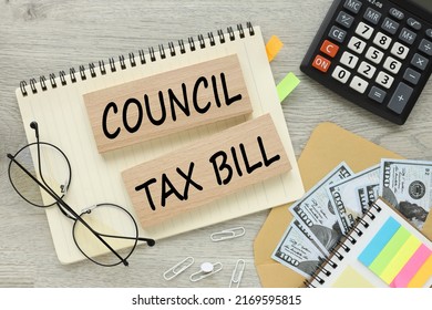 Council Tax Bill On Wooden Blocks On A Notepad. Wooden Background