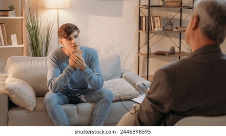 Counseling therapy. Psychology treatment. Healthcare consultation. Psychologist discussing mental health of curious man on session light room interior. - Powered by Shutterstock