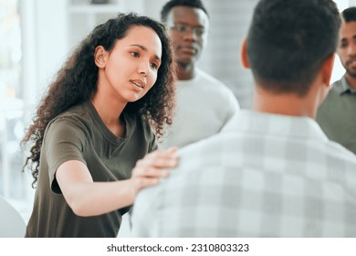 Counseling, woman with hand on man shoulder for comfort and in support center with members. Mental health or depression, group therapy or rehabilitation and people sitting together for recovery - Powered by Shutterstock