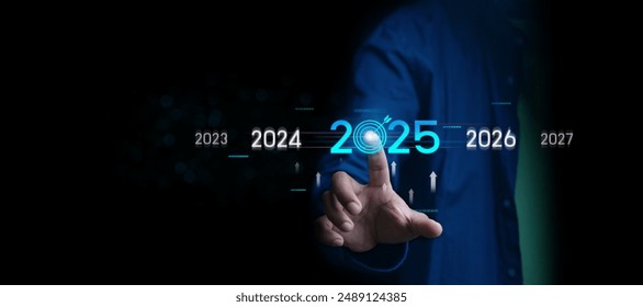 Countdown to 2025 concept. the taps a virtual download bar with a loading progress meter on New Year's Eve, turning the year 2024 to 2025.