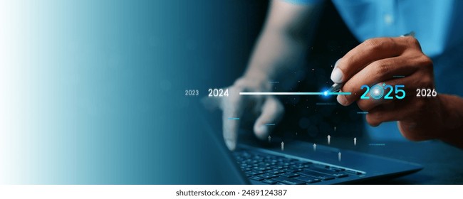 Countdown to 2025 concept. the taps a virtual download bar with a loading progress meter on New Year's Eve, turning the year 2024 to 2025.