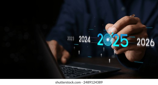 Countdown to 2025 concept. the taps a virtual download bar with a loading progress meter on New Year's Eve, turning the year 2024 to 2025.