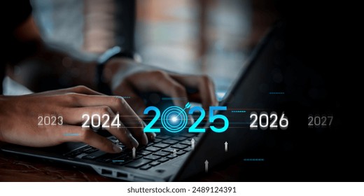 Countdown to 2025 concept. the taps a virtual download bar with a loading progress meter on New Year's Eve, turning the year 2024 to 2025.