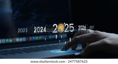 Countdown to 2025 concept. the taps a virtual download bar with a loading progress meter on New Year's Eve, turning the year 2024 to 2025.