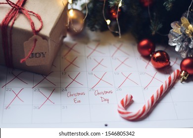 Countdown to Christmas with a calendar, wrapped present and decorations - Powered by Shutterstock