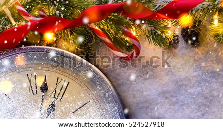 Countdown to midnight. Retro style clock counting last moments before Christmas or New Year 2017 next to decorated fir tree. View from above.