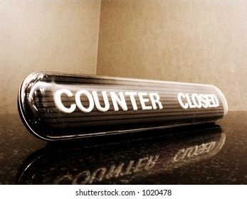 a 'counter closed' sign. Noise added for effect. slight sepia toned.