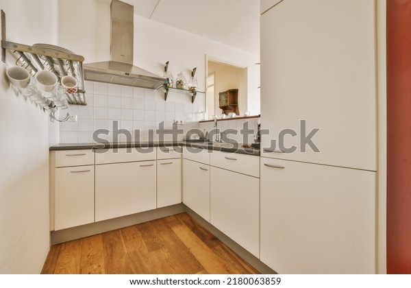Counter with dividing kitchen with\
modern furniture from dining area in contemporary\
flat