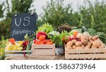 A counter with seasonal vegetables and U.S. farmers inscriptions