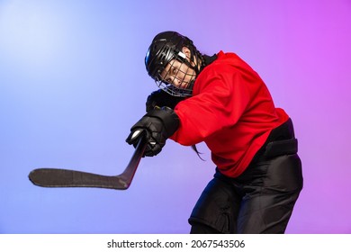 Counterattack. Professional female hockey player training in special uniform isolated over gradient blue purple background. Winning match. Concept of sport, action, movement, health. Copy space for ad