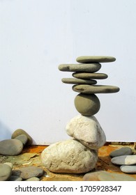 counterbalanced stones of irregular form on white background