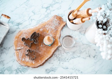 The countertop is set for baking, featuring cookie cutters, rolling pins, and a small wooden dough cutter. A touch of festive decor and tools are neatly arranged for holiday treats. - Powered by Shutterstock