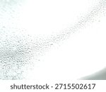 Countless tiny translucent water droplets create a dense, repetitive pattern of condensation on a smooth, reflective surface.