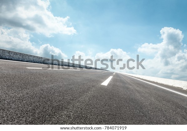 country\
asphalt road and blue sky and white clouds\
scene