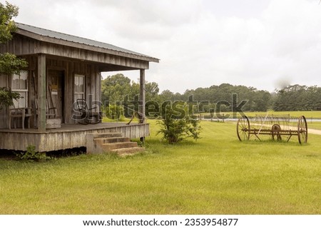 Country cabin porch in pastoral setting.