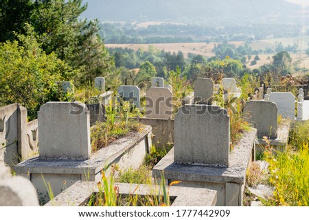 Country cemetery with green plants in Turkey at sunset
