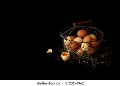 Country Eggs In A Vintage Metal Mesh Basket On Black Background. Free Copy (text) Space. Rustic Kitchen - Dark Moody Still Life.