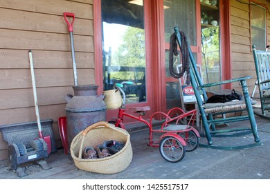 Country Farmhouse Front Porch With Antiques And Well Worn Shoes