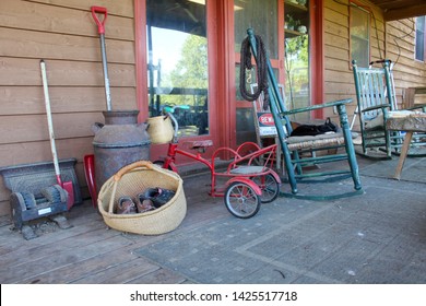 Country Farmhouse Front Porch With Antiques And Well Worn Shoes