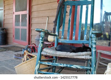 Country Farmhouse Front Porch With Antiques And Well Worn Shoes