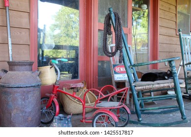 Country Farmhouse Front Porch With Antiques And Well Worn Shoes