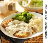 country fried steak with southern style peppered milk gravy