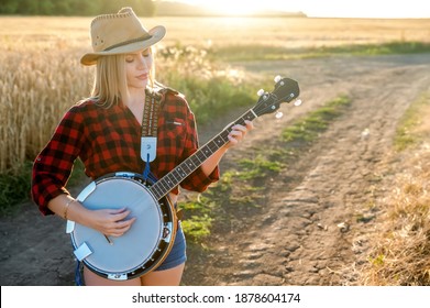 A Country Girl With A Banjo Stays In A Field