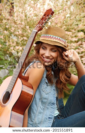 Country hippie girl with guitar
