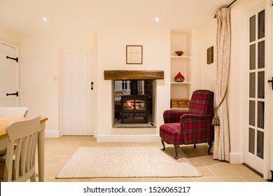 Country home interior, open plan room with wood burning stove in winter - Powered by Shutterstock