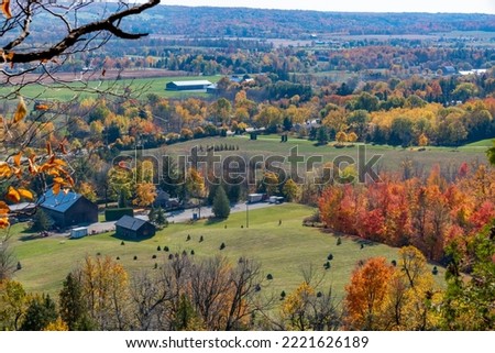 A country home is nestled amongst the Autumn colours as seen from Rattlesnake Point Conservation Area near Milton, Ontario.