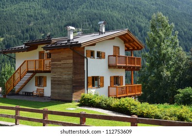 Country house in Alpine village. Sunny summer day. Dolomites, Val di Fassa, Italy.