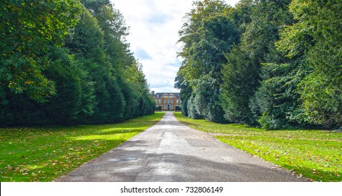 A Country House Driveway With The House In The Distance